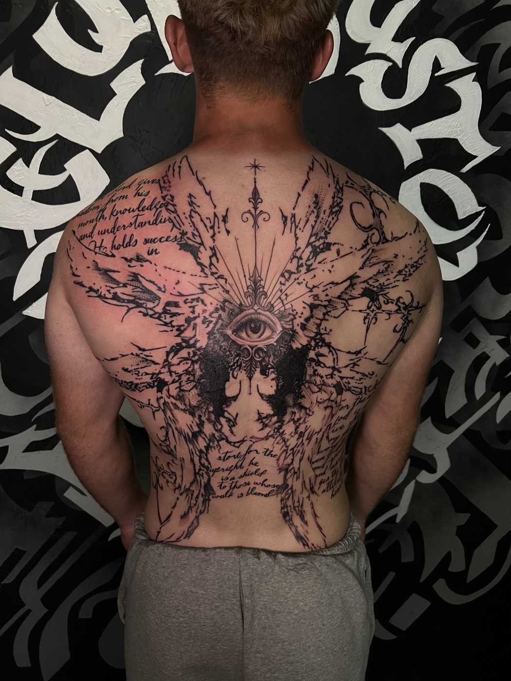 Eye and blackwork wings with script, full back tattoo by Bri, Kustom Tattoo Club