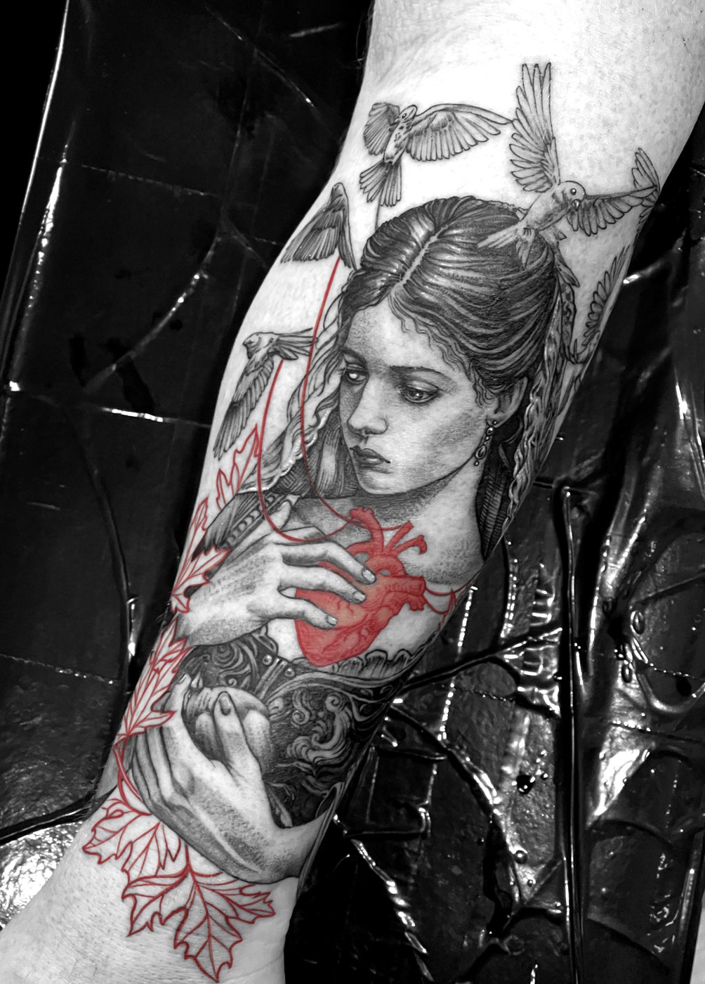 Woman holding a red anatomical heart tattoo by Katy, Kustom Tattoo Club