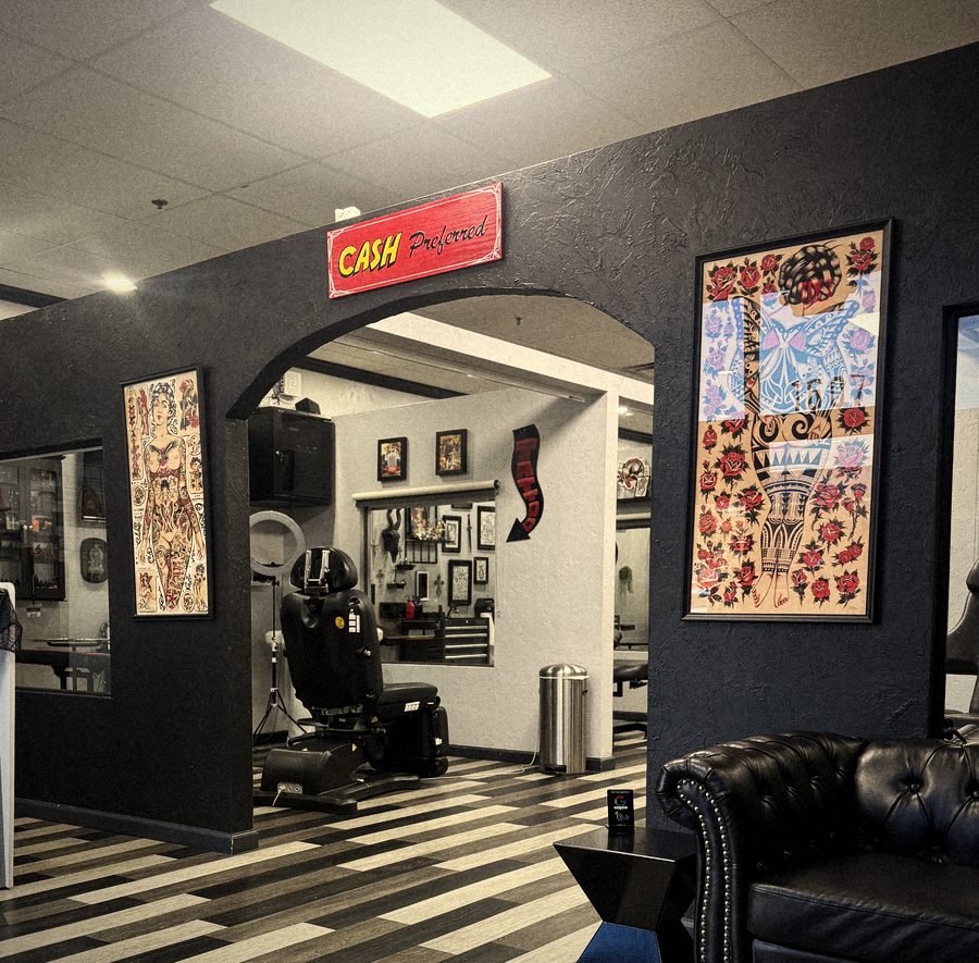 Front lobby with black arch, CASH Preferred sign, flash art and black tufted sofa