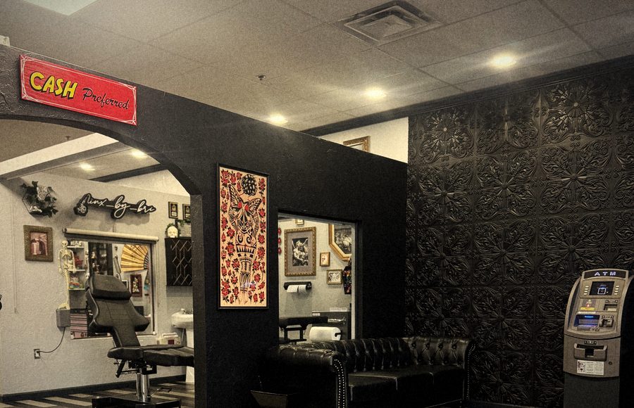 Lobby with black arch, tufted sofa, black embossed tile wall and ATM