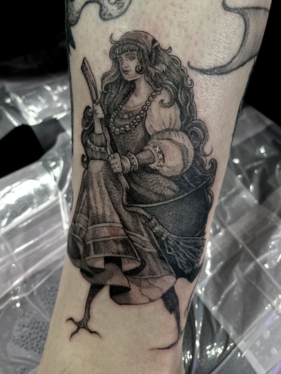 Black and grey woman with broom, tattoo by Trin, Kustom Tattoo Club