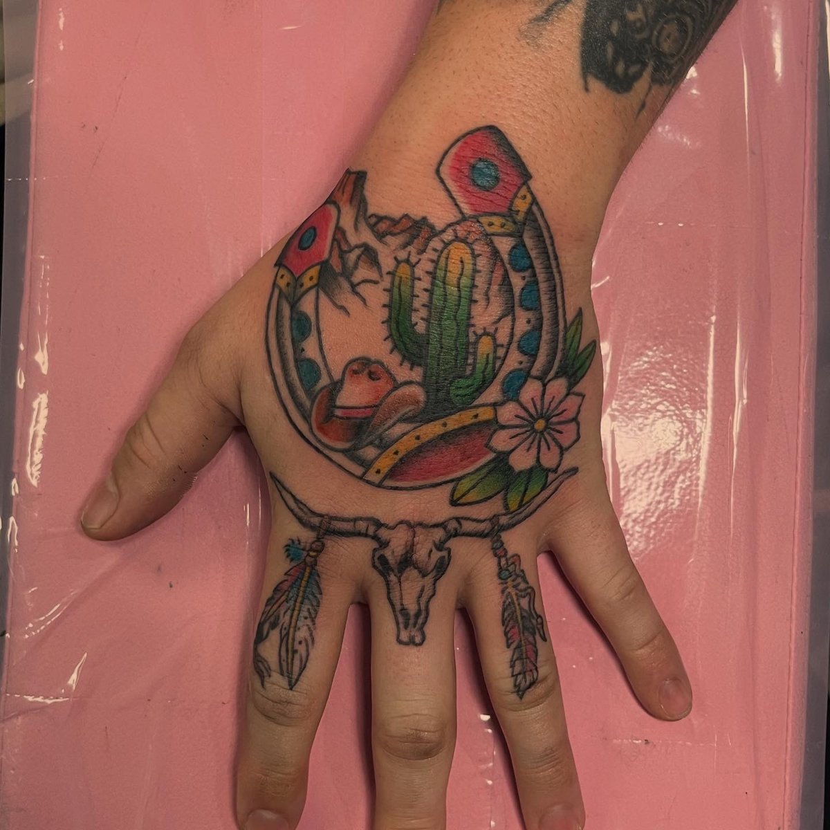 Western horseshoe and cactus hand piece, tattoo by Trin, Kustom Tattoo Club